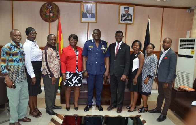 Mr David Asante Apeatu IGP and Mr Miyi Ojuolape UNFPA Representative in a group photo with staff from both institutions