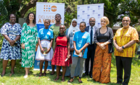 The Ambassadors and mentors in a group photograph with the adolescent girls.