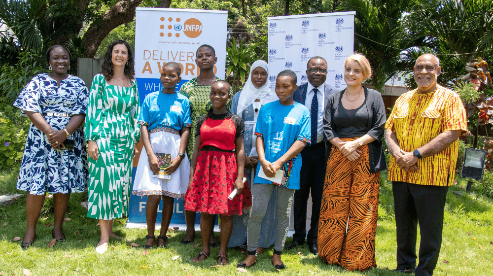 The Ambassadors and mentors in a group photograph with the adolescent girls.